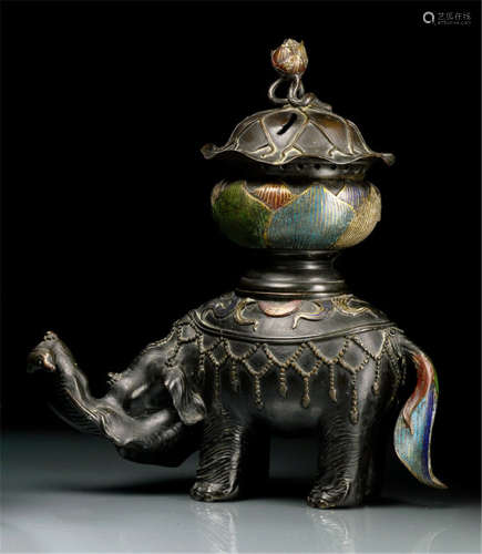 A BRONZE KORO IN THE SHAPE OF A STANDING ELEPHANT CARRYING A LOTUS BUD WITH LEAF ON HIS BAG, Japan, 19th Ct., details decorated with champlevé enamelling - Property from a German private collection - Some wear due to age