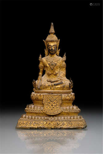 A GILT- AND BLACK-LACQUERED BRONZE FIGURE OF THE BUDDHA SHAKYAMUNI, THAILAND, RATNAKOSIN PERIOD, 19th ct., seated in sattvasana on a tiered base with his right hand in bhumisparshamudra and his left resting on his lap and his face displaying a serene expression - Property from an old Bavarian private collection, acquired between 1960 and 1990 - Minor wear, very slightly chipped