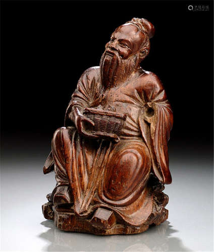 A BAMBOO CARVING OF A SEATED SCHOLAR HOLDING A BASKET WITH INCENSE