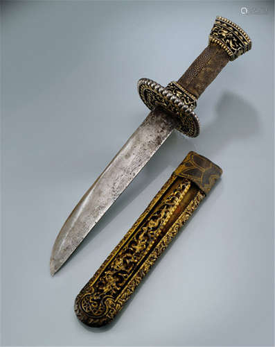 A GILT-IRON, SILVER, WOOD AND RAY-SKIN KNIFE, TIBET or BHUTAN, ca