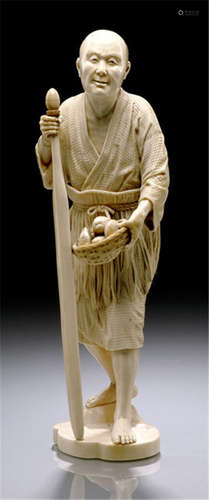 AN IVORY OKIMONO OF A FISHERMAN, Japan, signed Jumei (=Kanae Yoshio), Meiji period, in standing posture, wearing a bast apron, holding a long paddle in his right hand and a basket with various shells in his left - Property from a French private collection, acquired at Portier Piasa, 24th Oct 2007, lot 300 - Minor wear, right hand and foot re-stuck