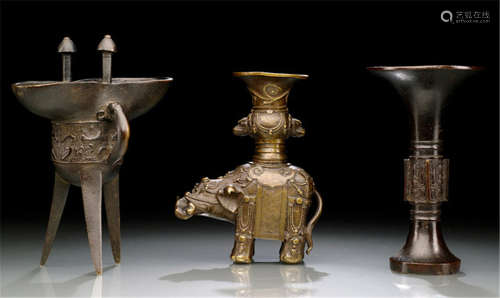A GROUP OF THREE BRONZES IN ARCHAIC STYLE
