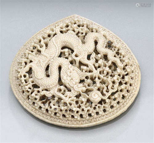 A VERY FINE CARVED IVORY PANEL WITH FIVE-CLAWED DRAGON AND WAVES