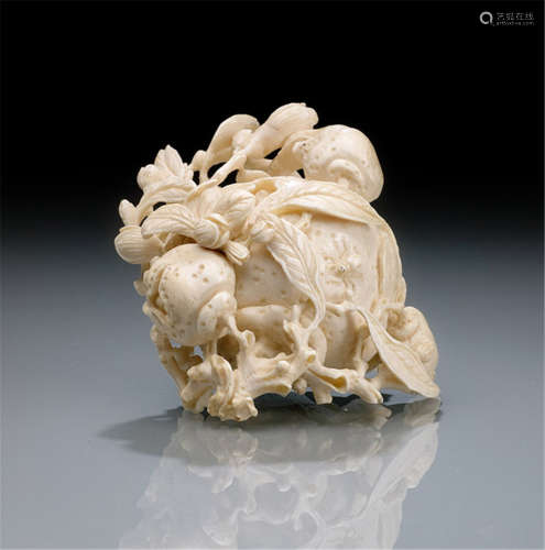 A FINE IVORY CARVING OF A POMEGRANATE COVERED WITH LEAVES AND SPRAYS-China