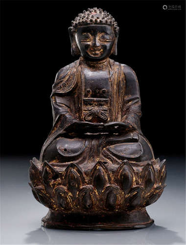 A BRONZE FIGURE OF BUDDHA SHAKYAMUNI, China or Korea, late Ming dynasty, seated in vajrasana on a lotus base with both hands in dhyanamudra, wearing monk's garb, his face displaying a serene expression with downcast eyes below arched eyebrows, his curled hair continuing into a low cranial protuberance and set with a ratna to the front, traces of gilt-lacquer - Property from a German private collection, assembled prior 1990 - very minor restorations