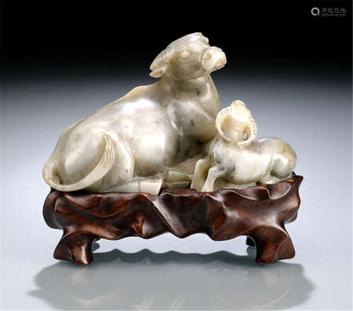 A SOAPSTONE CARVING OF TWO RECUMBENT BUFFALOES, China, Qing dynasty, wood stand-Property from an old European private collection, bought in the 1920s and 30s with Kleykamp, The Hague-Very slightly chipped