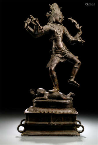 BRONZE OF SHIVA, India, standing in dancing posture on a figure reclining on a lotus base placed on a rectangular base, his four arms radiating around him, his face displaying a serene expression and his hair combed in the jatamakuta - Property from a German private collection, collected between 1966 and 2004 - Minor wear