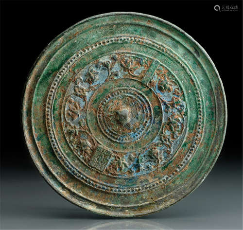 A BRONZE MIRROR WITH CONCENTRIC LOTUS SCROLL PATTERN