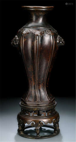 A LARGE LOBED BRONZE VASE ON STAND