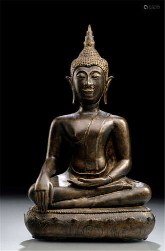 A BRONZE FIGURE OF BUDDHA SHAKYAMUNI, Thailand, Lanna period, 16th Ct. , seated in virasana on a lotus base with his right hand in bhumisparshamudra while the left rests on his lap, his face displaying a serene expression with downcast eyes below arched eyebrows, curled hair and ushnisha topped with a flame, traces of gilt- and black-lacquer - Property from a German private collection, assembled between 1966 and 2004 - Traces of age