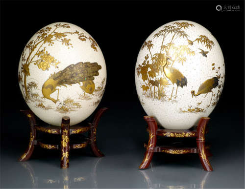 TWO OSTRICH EGGS, Japan, one sealed Keigai, Meiji period, decorated in gold and silver hiramaki-e, takamaki-e, togidashi-e and kirigane. One egg with two karako, a pair of pheasants and various birds amongst peonies and bamboo, the other with a pair of peacocks, pidgeons amongst peonies and flowering prunus - Former property from an old Berlin private collection - Minor wear, the gold lacquer partly restored