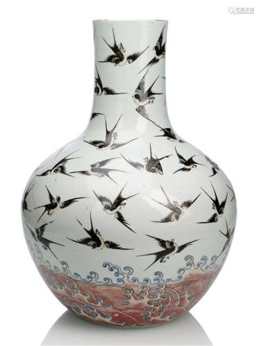 A WELL PAINTED PORCELAIN BOTTLE VASE WITH MAGPIES ABOVE WAVES IN COPPER-RED AND UNDERGLAZE-BLUE