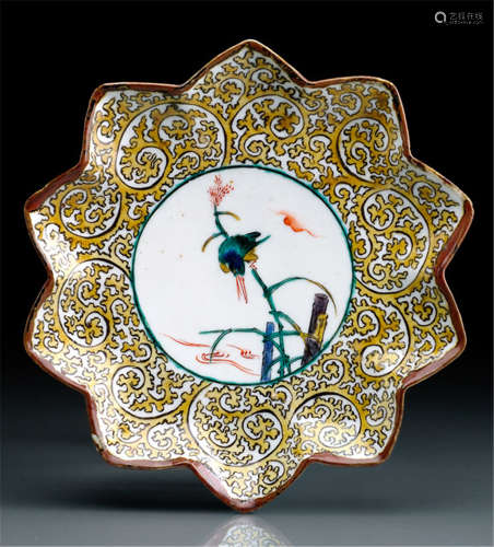 A KUTANI STAR-SHAPED DISH, Japan, 'fuku' mark on the reverse, late 17th ct., decorated in iron-red, blue, green yellow and aubergine and black enamel, with a roundel enclosing a kingfisher perched on reed beside a stream, reserved in stylized karakusa pattern - A similar dish is illustrated in Susumu Shimazaki, Nippon Toji Zenshu, Vol. 26 Kutaniyaki, pl. no. 111 - Property from a French private collection - Minor wear, firing crack to stand