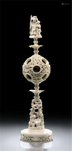 A FINE CARVED IVORY 'PUZZLED' BALL ON IVORY STAND WITH FIGURAL FINIAL, China, Jiaqing/Daoguang period - Very slightly chipped