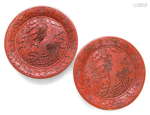 A PAIR OF RED CARVED DISHES DEPICTING PHOENIX AND PEONIES, China, 19th ct. - Property from an old Bavarian private collection - Slightly chipped