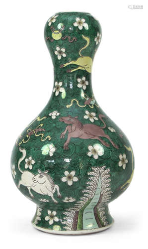 A DOUBLE-GOURD SHAPED PORCELAIN VASE DEPICTING HORSES, BLOSSOMS AND THE EIGHT PRECIOUS THINGS ON GREEN GROUND, China, Kangxi mark, 19th ct. - Property from a German private collection