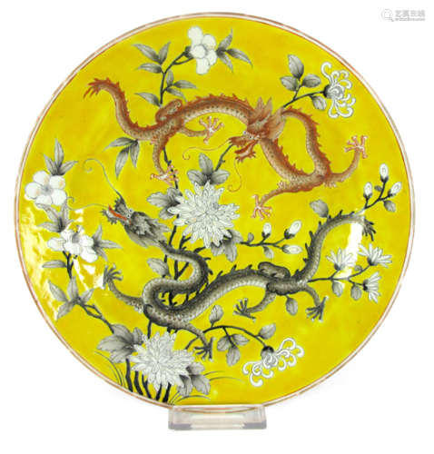 A PORCELAIN DISH DEPICTING A RED AND A BLACK DRAGON AND BLACK AND WHITE BLOSSOMS ON YELLOW GROUND, China, late Qing/Republic period, marked: xiezhu zhuren zao - Minor wear