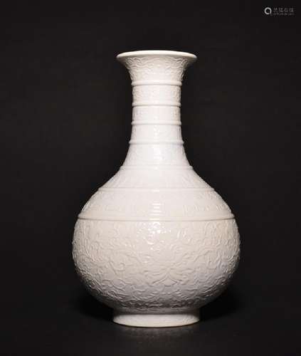 A CARVED WHITE-GLAZED BOTTLE VASE , Qing Dynasty