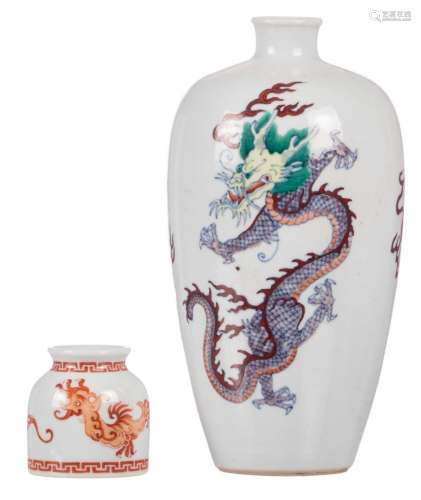 A Chinese doucai vase, decorated with dragons and flaming pearls, marked Kangxi, H 23,5 cm; added a Chinese iron red water pot, with a Yongzheng mark, H 6,5 cm