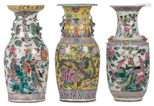Two Chinese famille rose vases, decorated with phoenixes, birds and flower branches; added a ditto yellow ground vase, decorated with a dragon and a phoenix, 19thC, H 45,5 - 46,5 cm