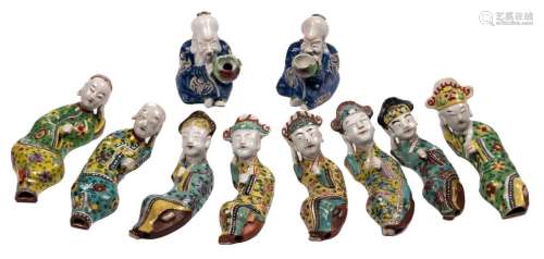 Eight Chinese polychrome decorated lying figures, about 1900, L 20 cm; added two Chinese polychrome decorated figure jugs, H 12 cm