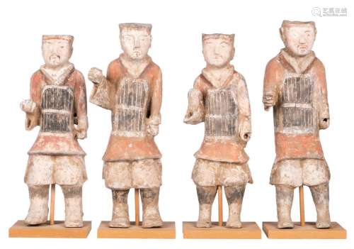 A set of four Chinese polychrome painted earthenware mingqi depicting servants, Tang dynasty, one with a thermoluminescence analysis report 'Oxford Authentification', H 50 - 53,5 cm