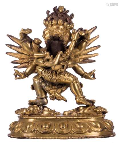 A Tibetan gilt bronze three headed and six armed Mahacakra Vajrapani, with traces of polychrom paint, H 14 - W 11 cm