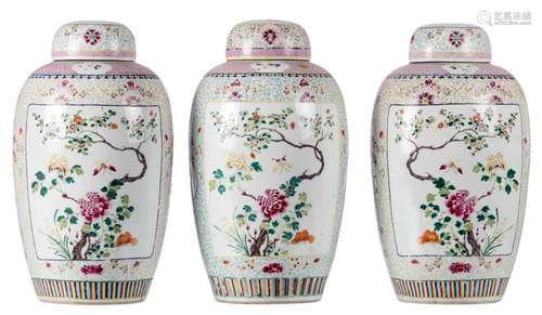 A set of three Chinese famille rose floral decorated vases and covers, the roundels with flower branches and butterflies, marked Qianlong, H 46 cm