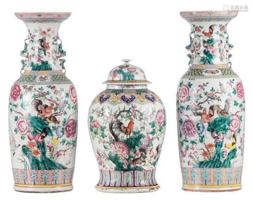 A pair of Chinese famille rose vases and one vase with cover, depicting flower rocks and cocks, 19thC, H 41 - 61 cm