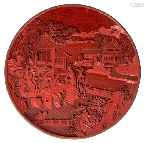 A large Chinese lacquer dish with a brass edge, depicting three ladies in a garden, Diameter 63 cm