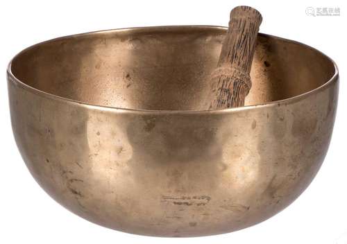 A Tibetan bronze singing bowl with a matching wooden bat, H 12 - Diameter 26 cm