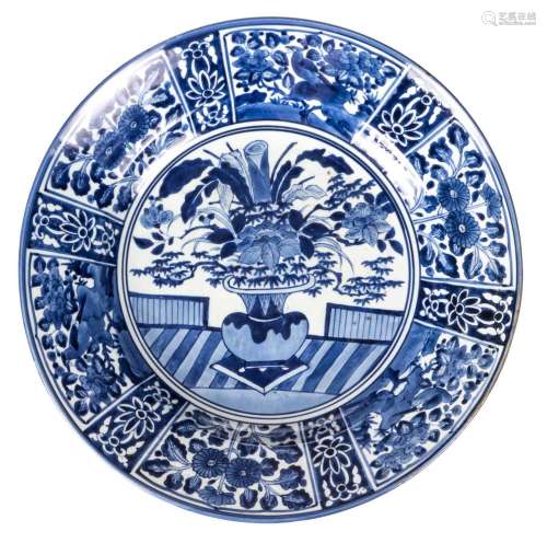 A large deep Japanese Arita type blue and white plate, depicting a vase with flowers and birds, 19thC, Diameter 55,5 cm