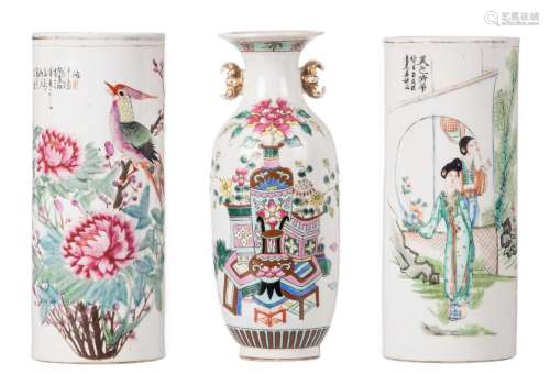 Two Chinese famille rose and polychrome decorated cylinder shaped vases, one signed; added a ditto vase, decorated with flower vases, antiquities and calligraphic texts, H 28 - 28,5 cm