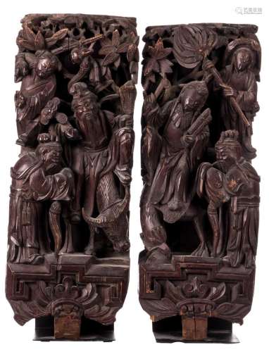 A pair of Chinese wooden alto relievo temple pieces depicting an animated scene, on a matching black metal base, about 1900, H 68 cm