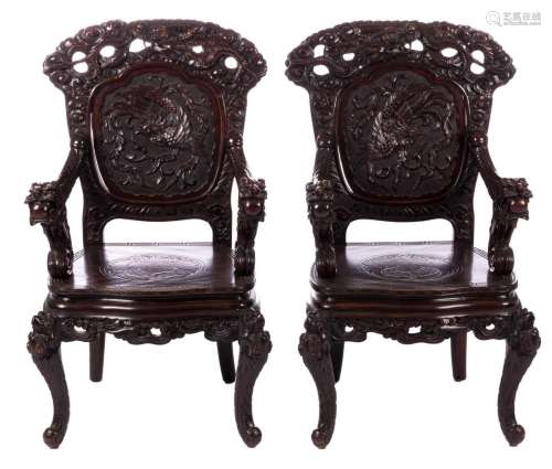 A pair of Chinese richly sculptured wooden armchairs, decorated with dragons and mythical birds, H 111- W 61 - D 53 cm