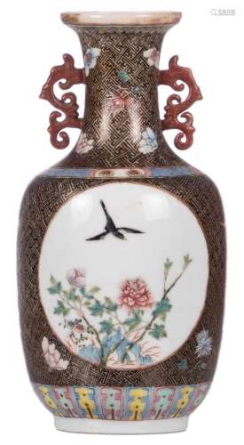 A Chinese famille rose floral decorated vase, the roundels with birds and flower branches, with a Qianlong-mark, H 22,5 cm