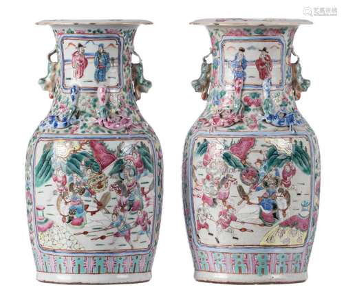 A pair of Chinese famille rose vases, decorated with a court scene and warriors, 19thC, H 36 cm