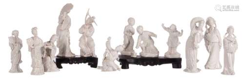 Two groups of Chinese Blanc de Chine figures, on a matching wooden base, H 10 - 16,5 cm; added seven ditto figures, H 11 - 17 cm