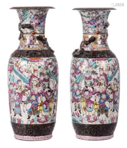 A pair of Chinese famille rose stoneware vases, overall decorated with warriors, dragon relief decorated, marked, 19thC, H 61 cm (chips)