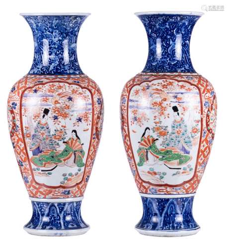 A pair of Japanese Imari baluster shaped vases, the roundels decorated with an animated scene, H 62 cm