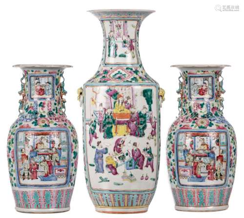 A pair of Chinese famille rose floral decorated vases, the roundels with a court and a warrior scene, 19thC, H 44,5 cm; added a dito vase decorated with court scenes, H 59,5 cm