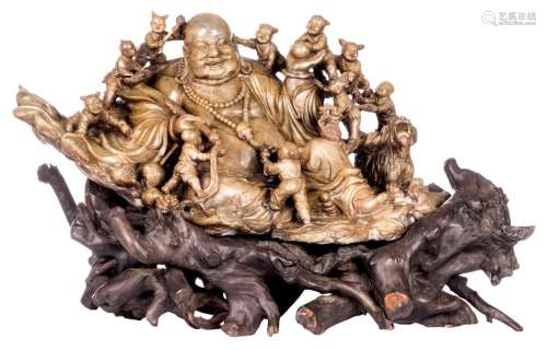 An exceptional Chinese Qing dynasty soapstone group of a Budai, surrounded by playing children, Fu lions and a rat, H 35 (without base) - 49 (with base) - W 75 - D 45 cm (damage)