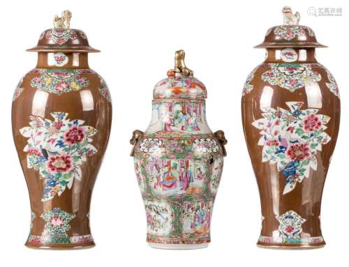 A pair of Chinese Batavia brown and famille rose floral decorated vases and covers, 19thC, H 47,5 cm; added a Chinese Canton vase and cover, H 40 cm