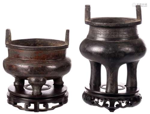 Two Chinese archaic bronze incense burner on a matching wooden base, H 14 - 16 (without base) 18 - 20 cm (with base)