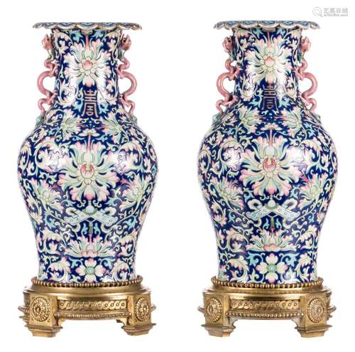 A pair of Chinese polychrome vases, relief decorated with dragons, symbols and floral motifs, with gilt bronze mounts, H 49,5 cm (one vase with cracks on the body and restored)