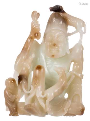 A Chinese jade figure depicting a Buddhist monk playing with dogs, H 15,5 cm