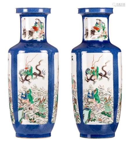 Two Chinese blue poudré famille verte rouleau shaped vases, the roundels decorated with animated scenes, with a Kangxi mark, H 65,3 cm