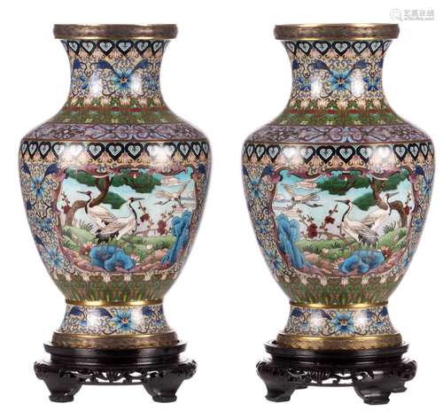 A pair of Chinese floral decorated cloisonné vases, the roundels with cranes, on a matching wooden base, H 38,5 (without base)- 44,5 cm (with base)