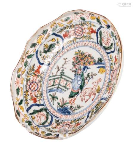 A Chinese transitional ko-sometsuke dish, wucai decorated with a figure and a deer in a garden, marked Tianqi, D 24 cm