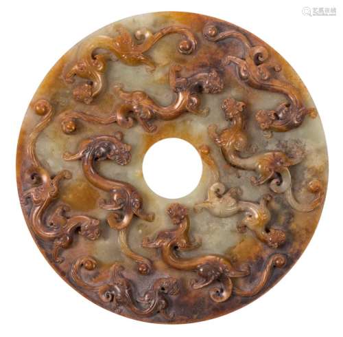 A Chinese green and brown jade Bi-disk, relief decorated with nine Chilong, Diameter 16,5 cm